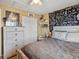 Bedroom with a unique accent wall and neutral-toned furnishings at 21351 E Williamette Pl, Centennial, CO 80015
