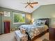Tranquil bedroom with large window and a decorative ceiling fan at 21351 E Williamette Pl, Centennial, CO 80015