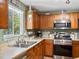 Well-lit kitchen featuring stainless steel appliances and natural light at 21351 E Williamette Pl, Centennial, CO 80015