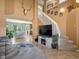 Cozy living room featuring a staircase, decorative fireplace, and open access to the kitchen at 21351 E Williamette Pl, Centennial, CO 80015
