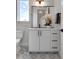 Elegant half-bathroom featuring a modern vanity, stylish mirror, decorative floor tiles, and sleek fixtures at 5148 W 44Th Ave, Denver, CO 80212