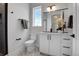 Stylish half-bathroom featuring a modern vanity, chic mirror, decorative floor tiles, and sleek fixtures at 5148 W 44Th Ave, Denver, CO 80212