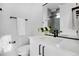 Elegant bathroom with white vanity, modern fixtures, and a sleek mirror, offering a clean and contemporary design at 5148 W 44Th Ave, Denver, CO 80212
