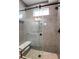 Modern bathroom featuring a glass shower enclosure, marble tile, and a built-in bench at 5148 W 44Th Ave, Denver, CO 80212