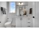 Chic half-bathroom featuring a modern vanity, stylish mirror, decorative floor tiles, and sleek fixtures at 5148 W 44Th Ave, Denver, CO 80212