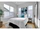 Bright bedroom featuring a plush bed, modern art, and large windows for natural light at 5148 W 44Th Ave, Denver, CO 80212
