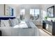 Bright bedroom features large windows, stylish decor, and ample sunlight creating a welcoming atmosphere at 5148 W 44Th Ave, Denver, CO 80212