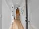 Inviting hallway with a view of the wooden staircase and contemporary wall art at 5148 W 44Th Ave, Denver, CO 80212