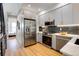 Modern kitchen featuring stainless steel appliances and ample cabinet space at 5148 W 44Th Ave, Denver, CO 80212