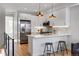 Open-concept kitchen with stainless steel appliances, bar seating, and modern lighting creating a welcoming and functional space at 5148 W 44Th Ave, Denver, CO 80212