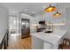 Bright, modern kitchen with stainless steel appliances, quartz countertops, and an open layout perfect for entertaining and cooking at 5148 W 44Th Ave, Denver, CO 80212
