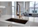 Modern kitchen features quartz countertops, a stainless steel sink, and a stylish gold faucet for a luxurious touch at 5148 W 44Th Ave, Denver, CO 80212
