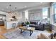Open-concept living space featuring sleek design, modern lighting and a stylish kitchen island with barstool seating at 5148 W 44Th Ave, Denver, CO 80212