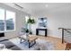 Bright living room boasting large windows, light wood floors, modern furniture, and an open floor plan at 5148 W 44Th Ave, Denver, CO 80212