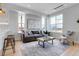 Inviting living room with a modern kitchen view, complemented by contemporary decor and bright, airy windows at 5148 W 44Th Ave, Denver, CO 80212