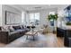 Bright living room featuring a comfortable sofa, modern decor, and large windows at 5148 W 44Th Ave, Denver, CO 80212
