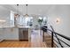 Open-concept living area featuring modern decor, large windows, and a stylish kitchen at 5148 W 44Th Ave, Denver, CO 80212
