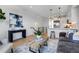 A modern living area with sleek finishes, stylish decor, a contemporary painting and an open kitchen concept at 5148 W 44Th Ave, Denver, CO 80212
