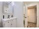 This bathroom features a vanity with storage, a mirror, and an open door to the shower at 4244 W Monmouth Ave, Littleton, CO 80123