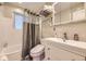 Cozy bathroom features a shower-tub combo and modern vanity with storage at 4244 W Monmouth Ave, Littleton, CO 80123