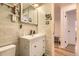 Bathroom featuring a modern vanity with storage and subway tile backsplash at 4244 W Monmouth Ave, Littleton, CO 80123
