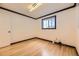 Bright bedroom featuring hardwood floors, white walls, and dark trim at 4244 W Monmouth Ave, Littleton, CO 80123