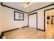 Bedroom with hardwood floors, closet, and natural light from window at 4244 W Monmouth Ave, Littleton, CO 80123