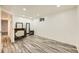 Well-lit bedroom featuring modern wood floors, white walls, and a vanity area with a lit mirror at 4244 W Monmouth Ave, Littleton, CO 80123