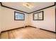 Bright bedroom with hardwood floors and a view from two windows at 4244 W Monmouth Ave, Littleton, CO 80123