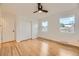 Inviting bedroom with hardwood floors, two windows, and a ceiling fan at 4244 W Monmouth Ave, Littleton, CO 80123