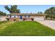 Charming ranch-style home with manicured lawn, brick accents, and a two-car garage at 4244 W Monmouth Ave, Littleton, CO 80123
