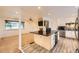 Eat in Kitchen with granite counters, stainless appliances and view of bright living room at 4244 W Monmouth Ave, Littleton, CO 80123