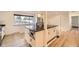 Kitchen showcases stainless appliances, stone floors and island, light filled space at 4244 W Monmouth Ave, Littleton, CO 80123