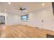Bright living room featuring hardwood floors, large windows, ceiling fan, and neutral paint at 4244 W Monmouth Ave, Littleton, CO 80123