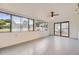 This sunroom features many windows providing bright light and a ceiling fan for air circulation at 4244 W Monmouth Ave, Littleton, CO 80123
