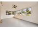Sunroom featuring many windows with views of the outdoors, grey floors, and a ceiling fan at 4244 W Monmouth Ave, Littleton, CO 80123