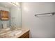 Bathroom featuring a granite countertop, wood cabinet, and large mirror at 6780 W 84Th Cir # 66, Arvada, CO 80003