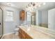 Well-lit bathroom featuring a granite countertop, a large mirror, and a glass-enclosed shower at 6780 W 84Th Cir # 66, Arvada, CO 80003