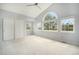 Spacious bedroom featuring vaulted ceilings, large windows with natural light, and a ceiling fan at 6780 W 84Th Cir # 66, Arvada, CO 80003