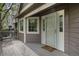 Cozy porch featuring a white door, gray decking, and windows that invite natural light into the home at 6780 W 84Th Cir # 66, Arvada, CO 80003