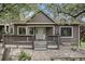 Charming home featuring a classic facade, inviting front porch, and flowering trees in a pleasant surrounding landscape at 6780 W 84Th Cir # 66, Arvada, CO 80003