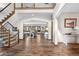 Spacious entryway with hardwood floors, staircase, and views into the living room at 7957 Towhee Rd, Parker, CO 80134