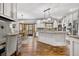 Spacious kitchen featuring a large island, stainless steel appliances, and a dining area at 7957 Towhee Rd, Parker, CO 80134