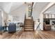 Cozy living room features a fireplace, hardwood floors, comfortable seating, and large windows at 7957 Towhee Rd, Parker, CO 80134