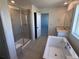 Modern bathroom with soaking tub, walk-in shower, and single sink vanity at 4225 Ridgewalk Pt, Castle Rock, CO 80108