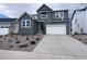 Modern two-story home featuring a two-car garage, complemented by professional landscaping for enhanced curb appeal at 4225 Ridgewalk Pt, Castle Rock, CO 80108