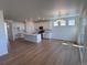 Open concept kitchen with white cabinets, stainless steel appliances, and a large center island at 4225 Ridgewalk Pt, Castle Rock, CO 80108