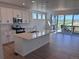 Modern kitchen features a large island, stainless steel appliances, and a sliding glass door leading to a deck with views at 4225 Ridgewalk Pt, Castle Rock, CO 80108