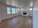 Bright living room with large windows providing plenty of natural light and a modern fireplace at 4225 Ridgewalk Pt, Castle Rock, CO 80108