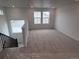 Upstairs loft area has neutral carpeting and windows for natural light at 4225 Ridgewalk Pt, Castle Rock, CO 80108